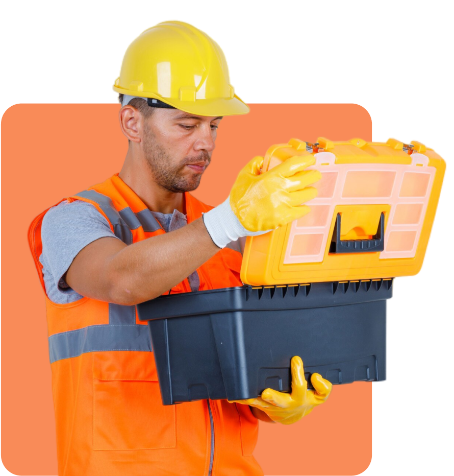 Man in safety gear holding and opening a tool box. He is wearing a yellow hard hat, orange safety vest, yellow gloves, and is examining the inside of the box.