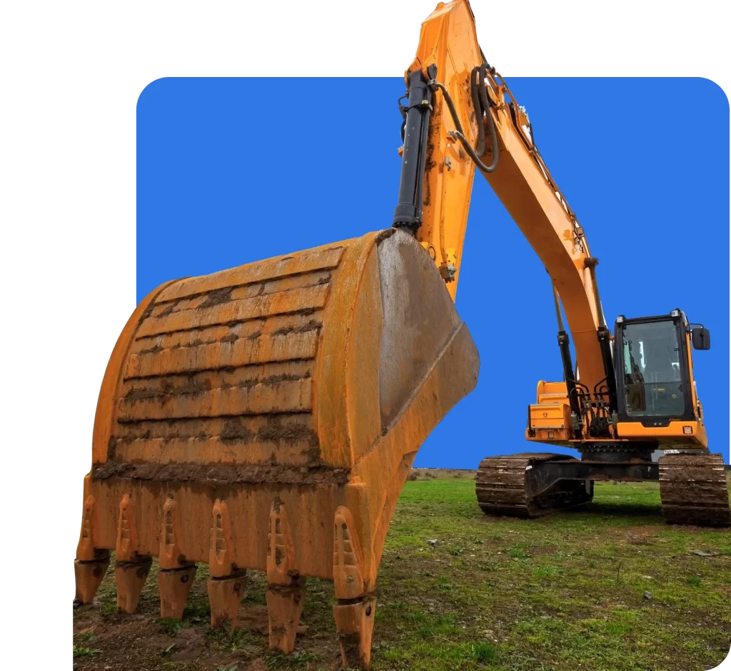 A yellow excavator with a large bucket attachment is positioned on a grassy surface against a blue background, showcasing the importance of earthmoving insurance for construction projects.