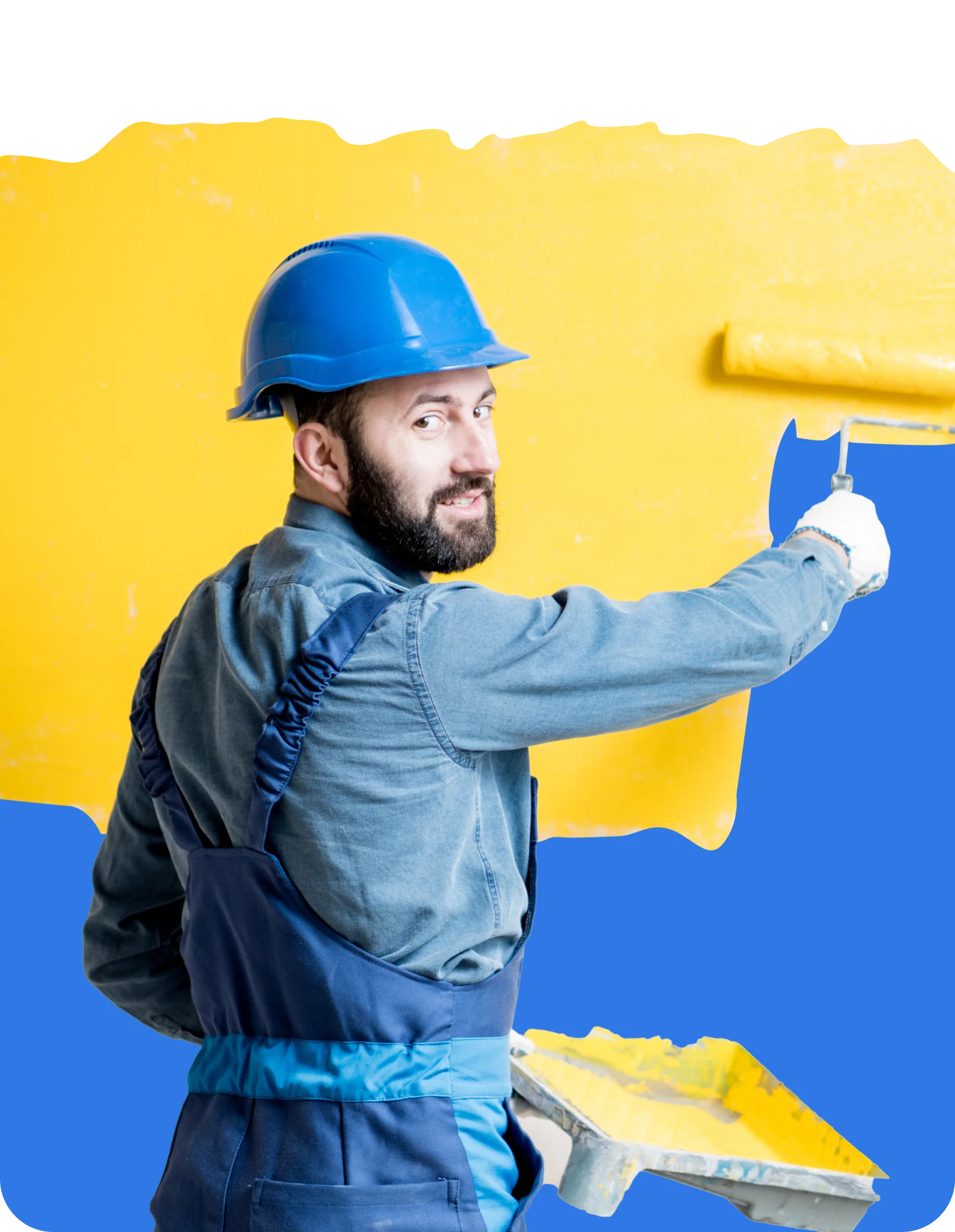 A man in a blue hard hat and overalls is using a paint roller to apply yellow paint to a wall, showcasing the importance of insurance for contractors who tackle these projects daily.