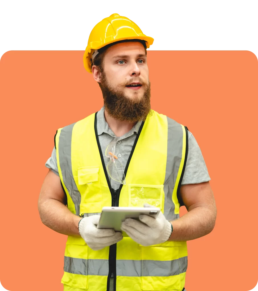 A construction worker wearing a yellow hard hat and high-visibility vest holds a tablet, ensuring all tasks comply with contractual liability insurance requirements.