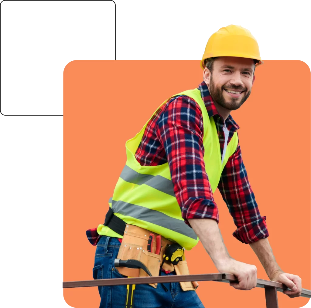 A construction worker wearing a yellow hard hat, a high-visibility vest, and a checkered shirt, smiling while grasping a railing against a solid orange background, embodying the security assured by contractual liability insurance.